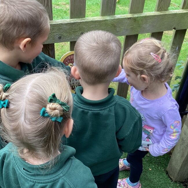 Infants looking at fence at nursery.